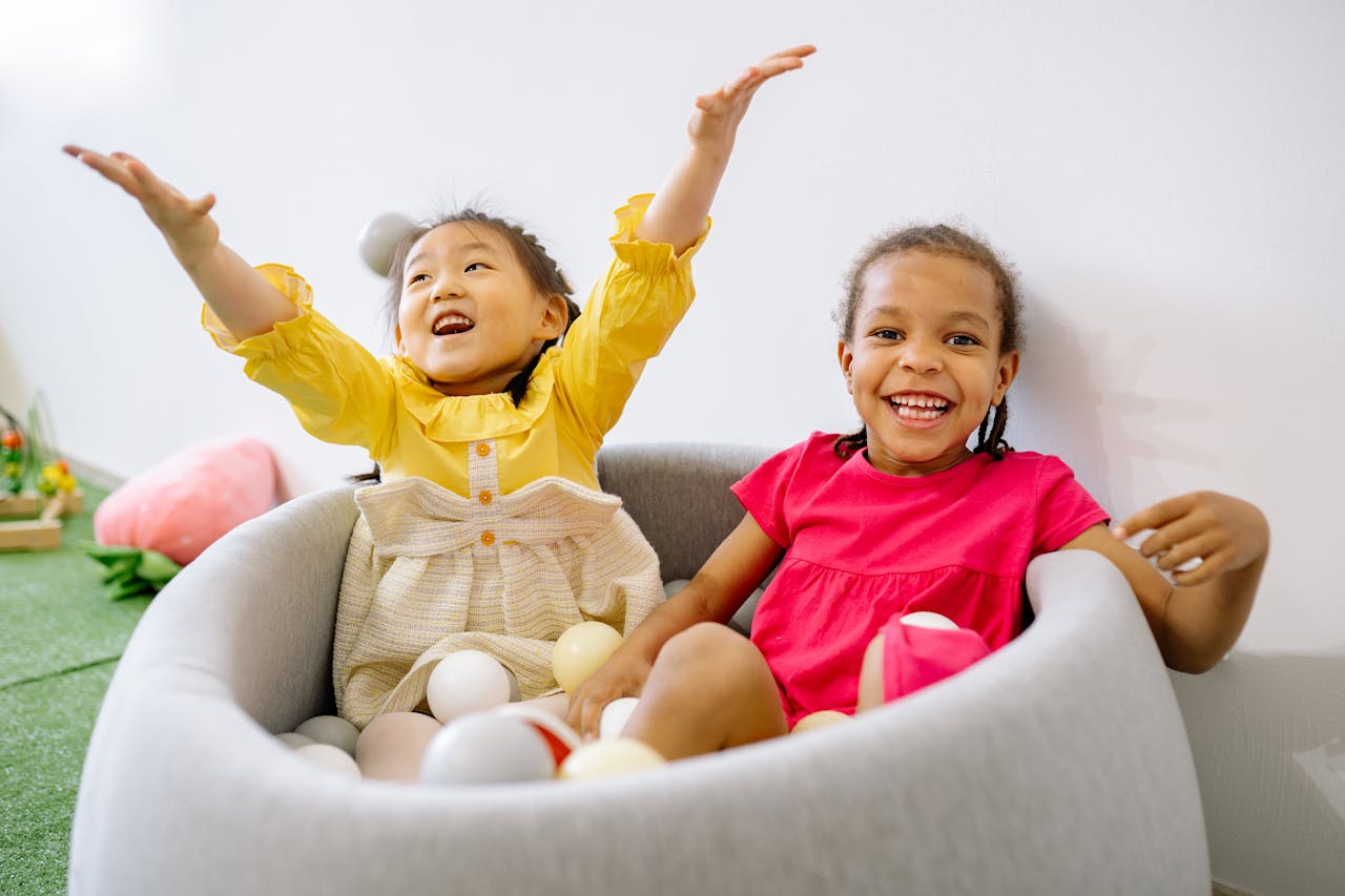 two children in a chair, smiling